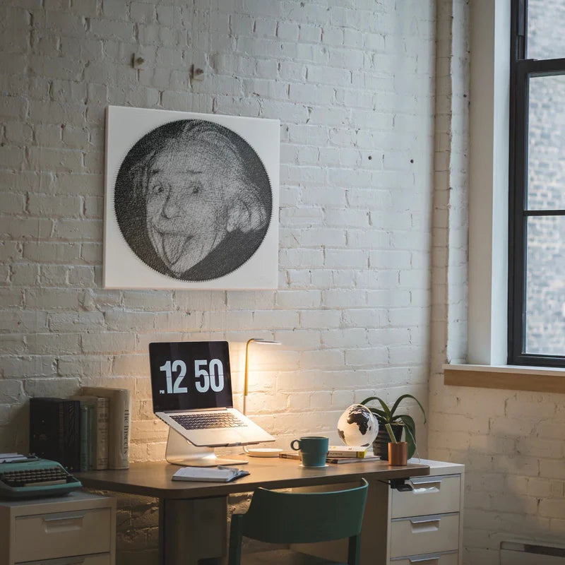 String art portrait displayed above a sideboard